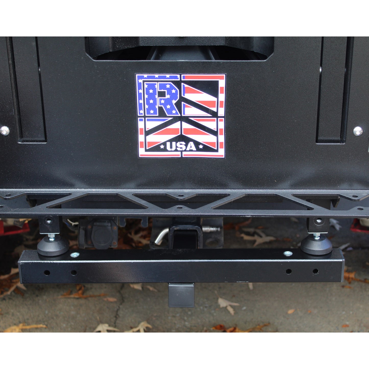 Black metal bumper with a logo on a vehicle
