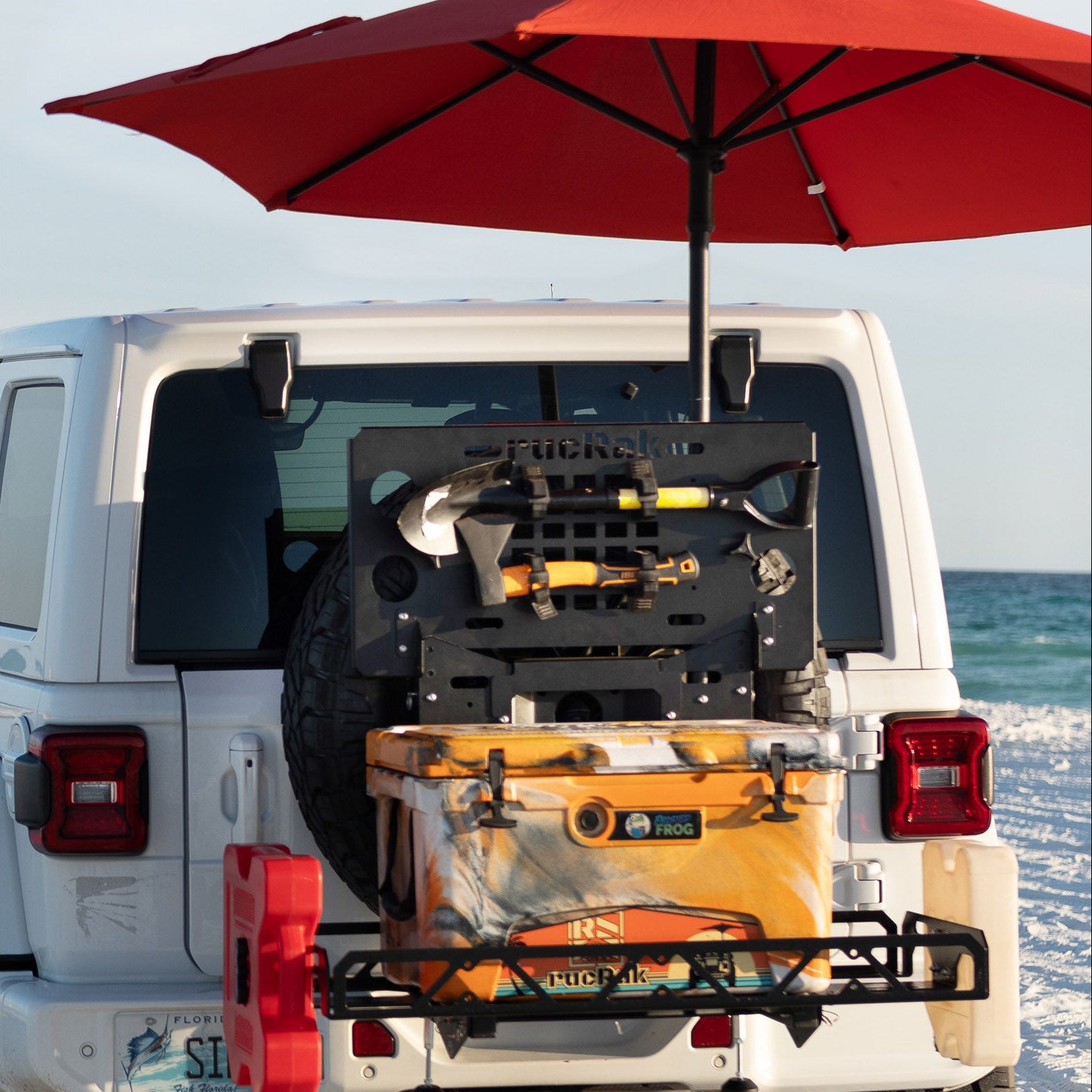 Umbrella and flag holder mounted on Jeep cargo carrier