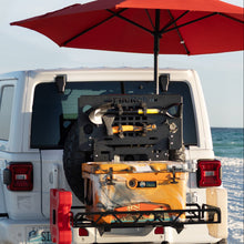 Umbrella and flag holder mounted on Jeep cargo carrier